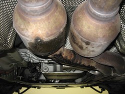 BMW exhaust system coated in engine oil from oil leak